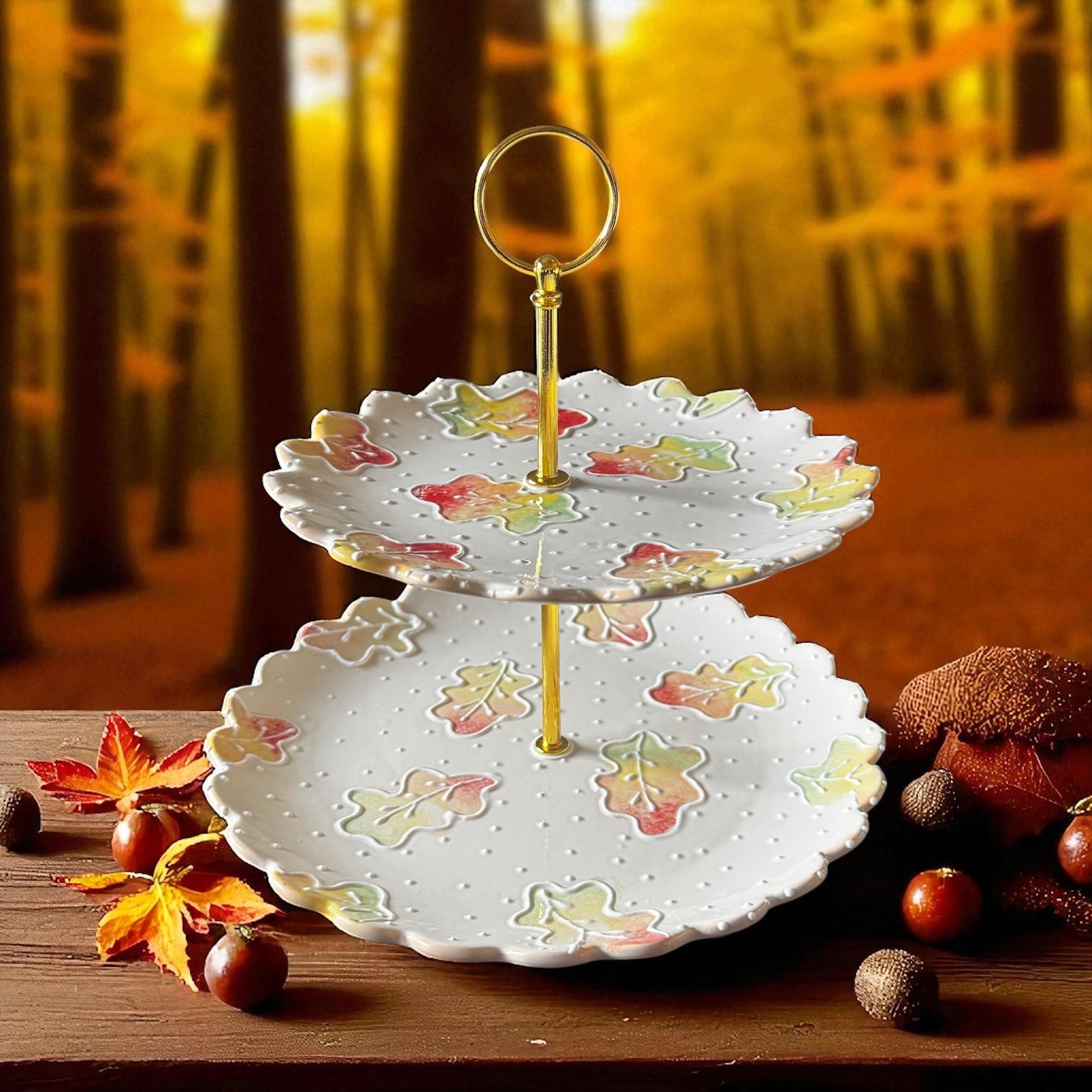 Two-tiered decorative plate with autumn leaf design on a wooden surface.