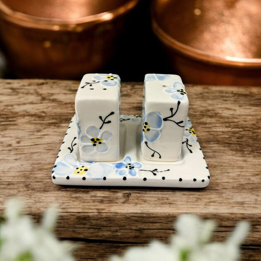 Hand-painted ceramic salt and pepper set with blue cherry blossom design